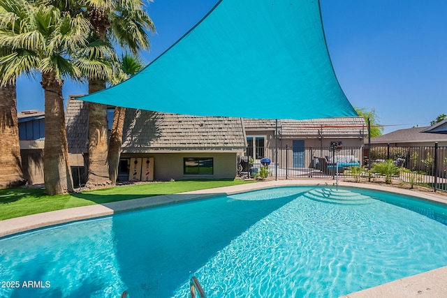 view of pool featuring fence