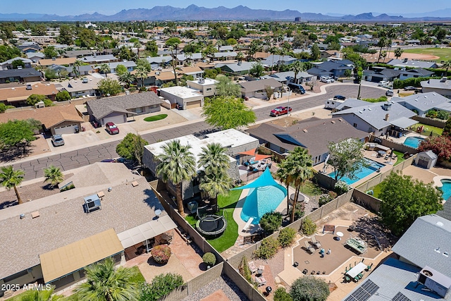 aerial view of residential area with a pool area and mountains