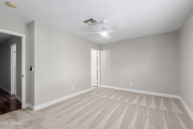 unfurnished room featuring carpet floors, a smoke detector, ceiling fan, and baseboards