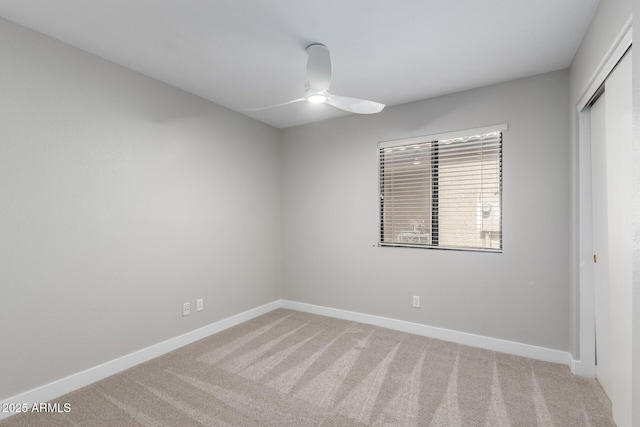 unfurnished room featuring carpet, ceiling fan, and baseboards