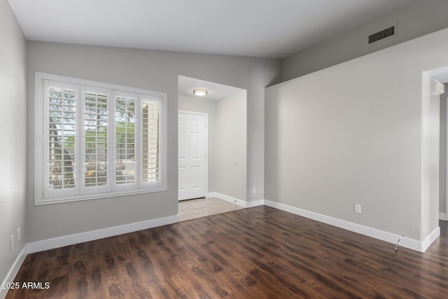 unfurnished room featuring wood finished floors and baseboards