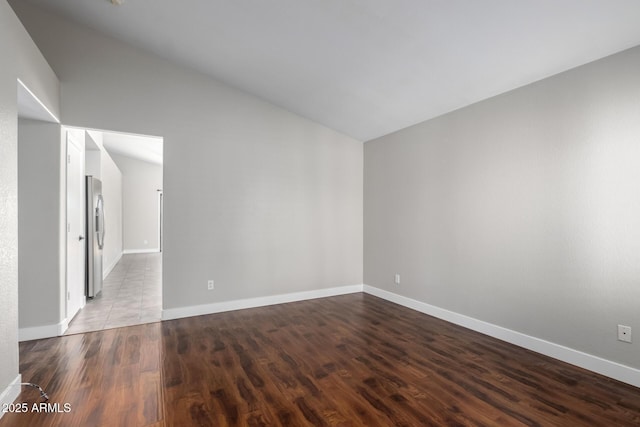unfurnished room with wood finished floors and baseboards