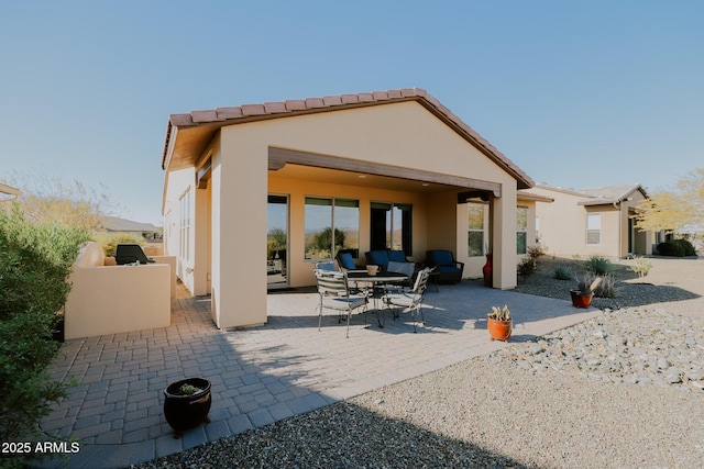 rear view of house with a patio