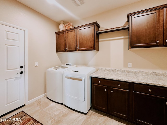 washroom featuring cabinets and washer and dryer