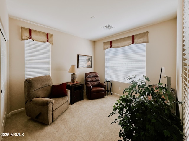 sitting room featuring light carpet