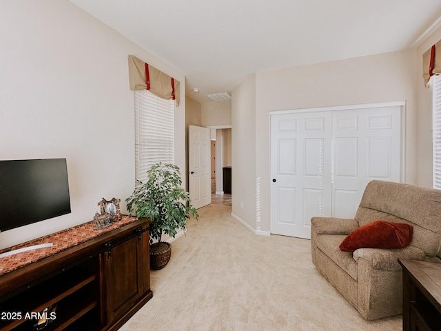 sitting room featuring light carpet