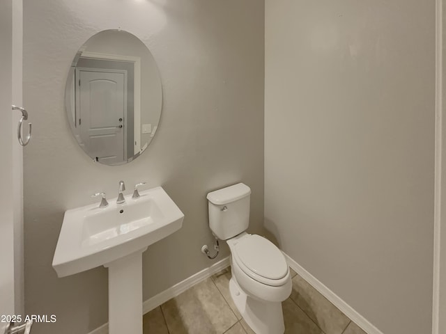 bathroom with tile patterned floors and toilet