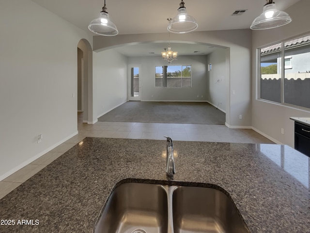 kitchen with decorative light fixtures, tile patterned flooring, and sink