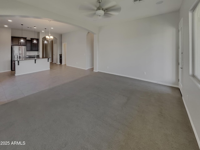 unfurnished living room featuring light colored carpet and ceiling fan