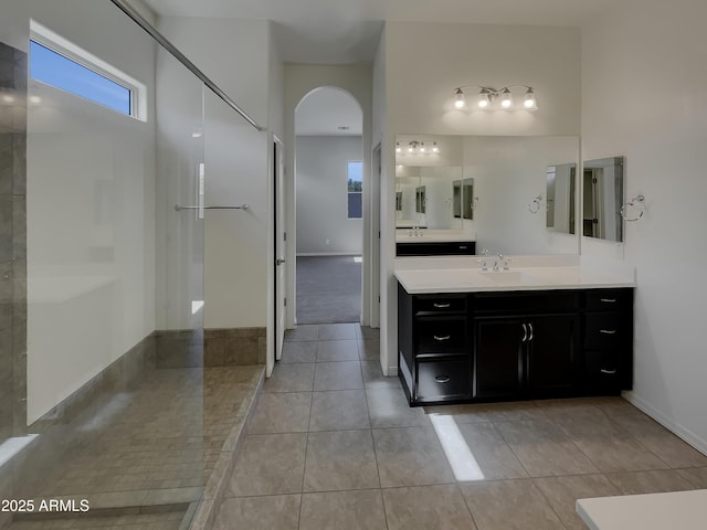 bathroom featuring vanity, a shower, and tile patterned floors