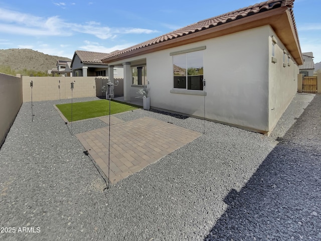back of house featuring a patio and a mountain view