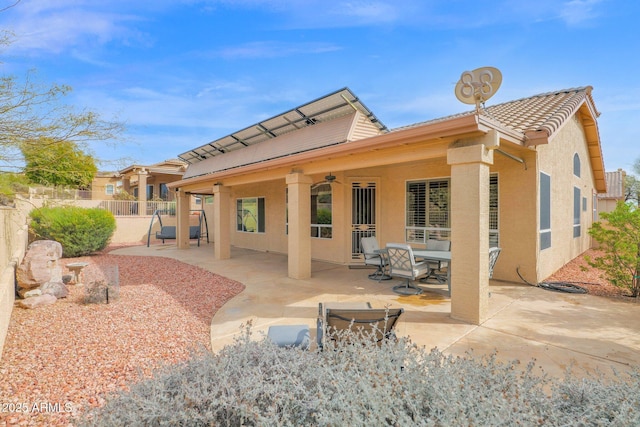 rear view of house featuring a patio and ceiling fan