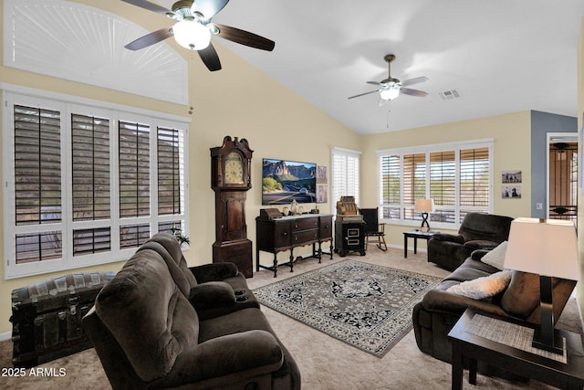 living room with ceiling fan, carpet flooring, and lofted ceiling