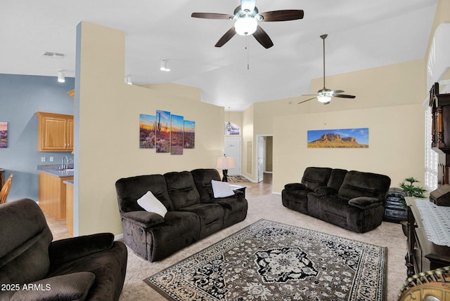 living room featuring sink, vaulted ceiling, and light colored carpet