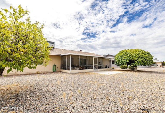 rear view of property with a patio area and a sunroom