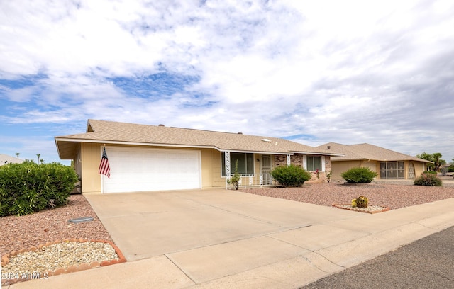 single story home featuring a garage and covered porch