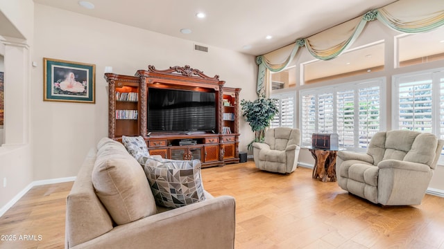 living area with baseboards, recessed lighting, visible vents, and light wood-type flooring