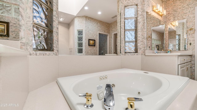 bathroom with recessed lighting and a whirlpool tub