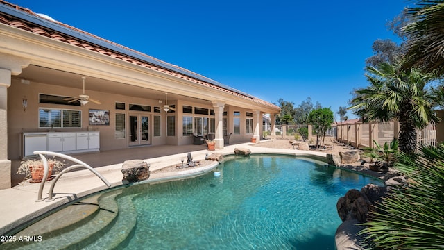 view of pool with a ceiling fan, a sink, fence, a patio, and a fenced in pool