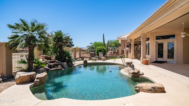 view of swimming pool featuring fence, a fenced in pool, french doors, and a patio