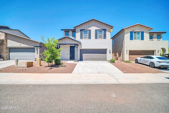 view of front of home with a garage, stucco siding, and driveway