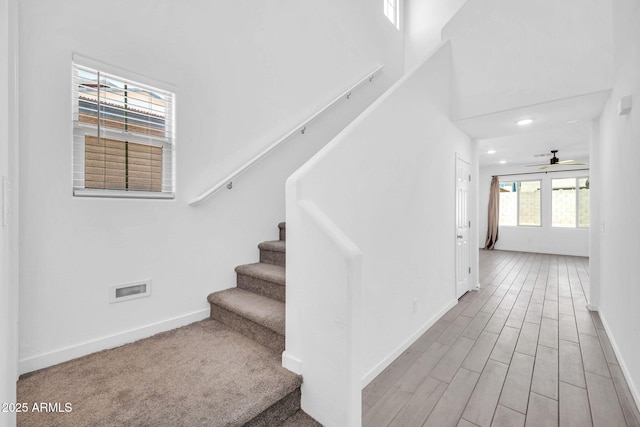 staircase with recessed lighting, baseboards, ceiling fan, and wood finished floors