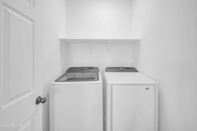 clothes washing area featuring laundry area and washer and dryer