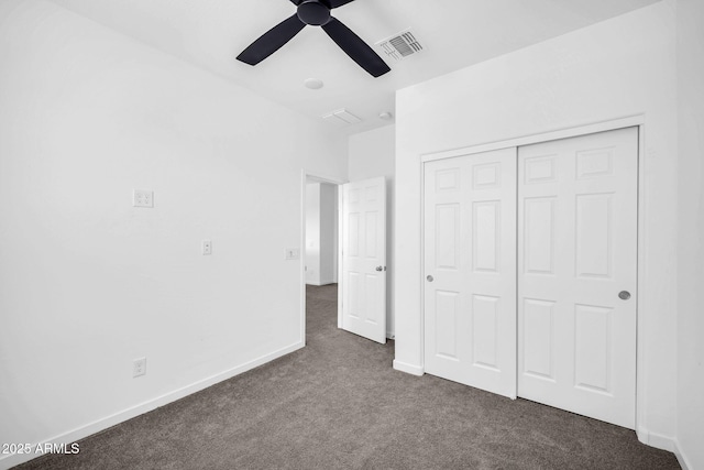 unfurnished bedroom featuring ceiling fan, visible vents, baseboards, a closet, and dark colored carpet