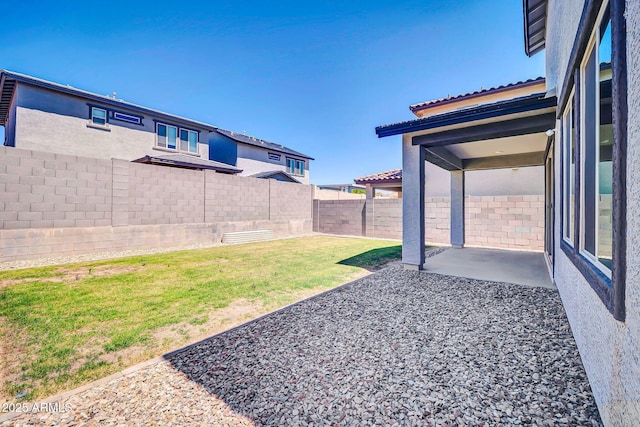 view of yard with a fenced backyard and a patio