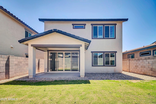rear view of property with a lawn, a patio, a fenced backyard, and stucco siding