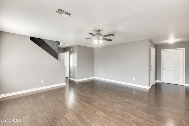 unfurnished living room featuring dark hardwood / wood-style floors, a textured ceiling, and ceiling fan