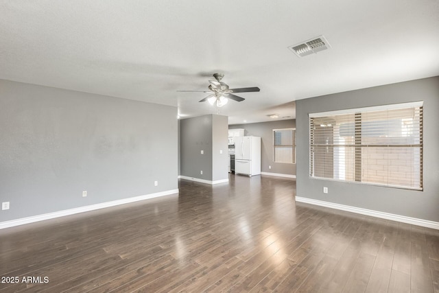 unfurnished living room with dark wood-type flooring and ceiling fan