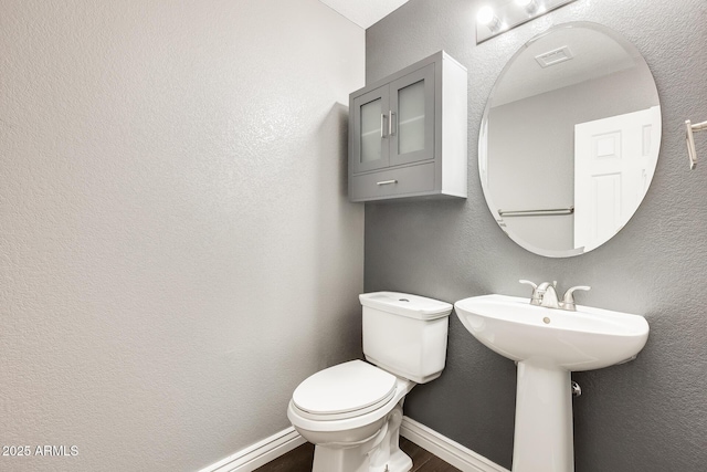 bathroom with wood-type flooring and toilet