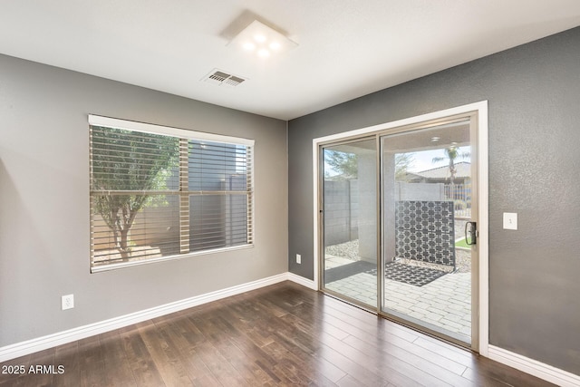 spare room featuring dark hardwood / wood-style floors