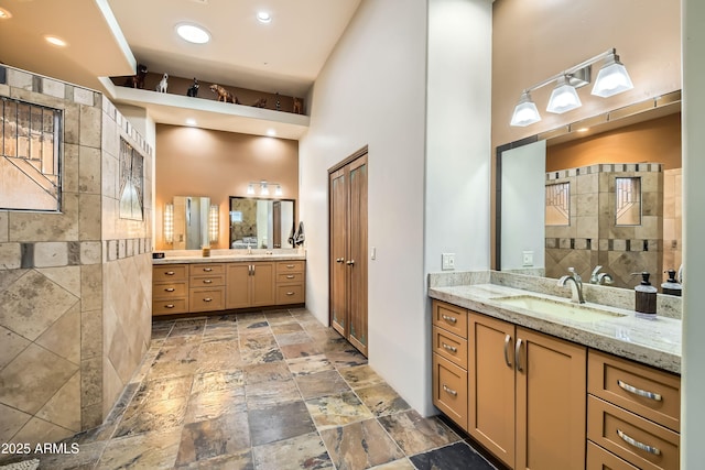 bathroom featuring vanity and a towering ceiling