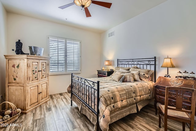 bedroom with wood-type flooring and ceiling fan