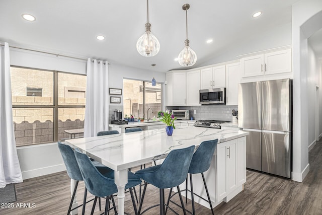 kitchen featuring stainless steel appliances, a chandelier, white cabinets, dark wood-style flooring, and recessed lighting