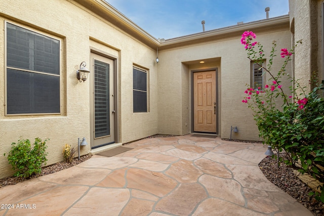 entrance to property with a patio