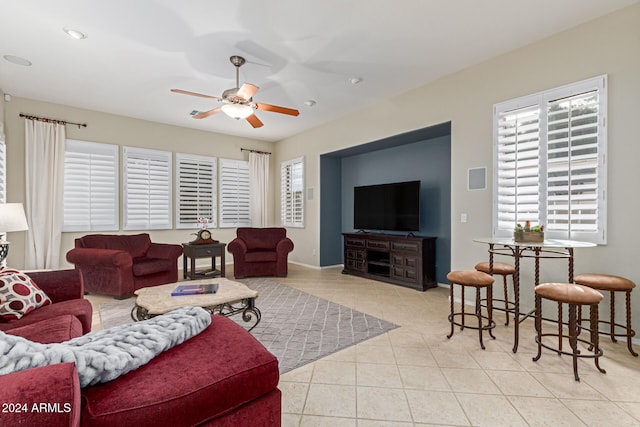 tiled living room featuring a healthy amount of sunlight and ceiling fan