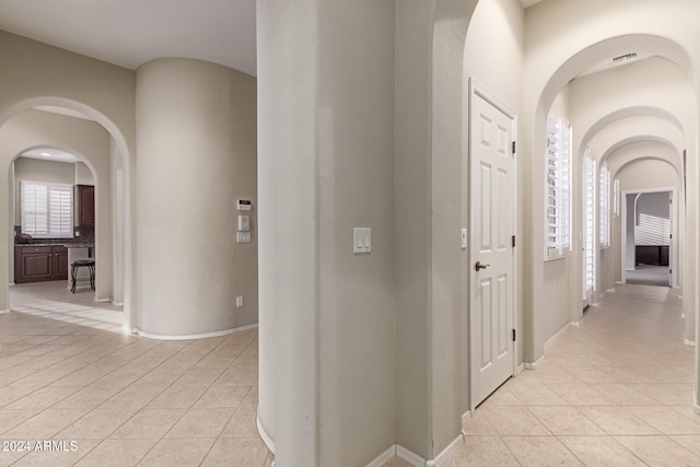 hallway featuring light tile patterned flooring