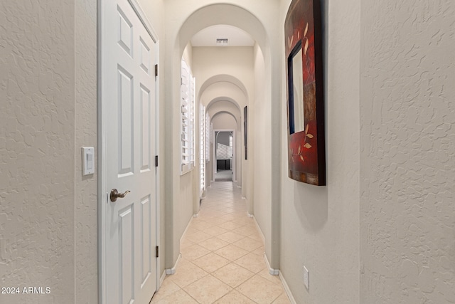 hallway featuring light tile patterned floors