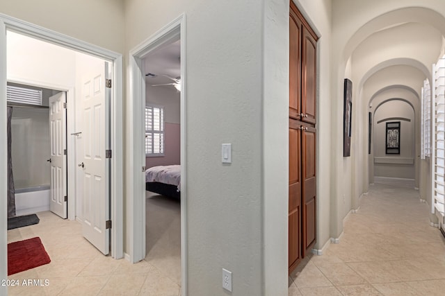 hall with light tile patterned floors