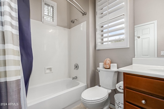 full bathroom with toilet, vanity, and shower / tub combo