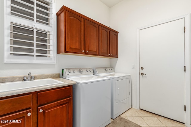 washroom with washer and dryer, cabinets, sink, and light tile patterned floors