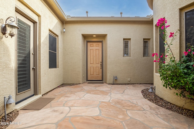 doorway to property featuring a patio area