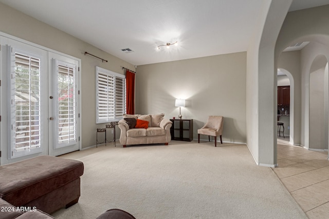 carpeted living room with french doors