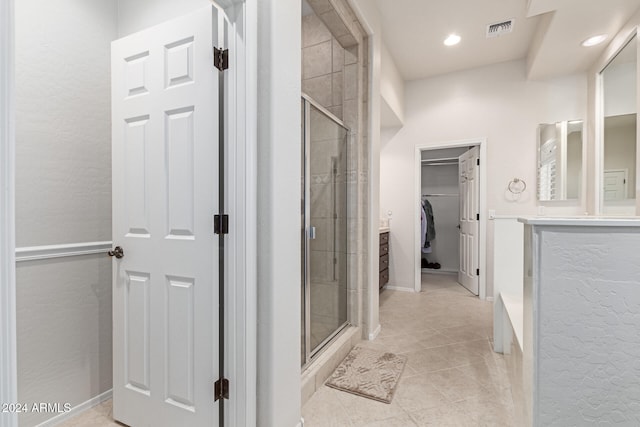 bathroom with vanity, walk in shower, and tile patterned flooring