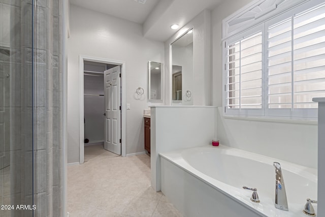 bathroom featuring vanity, plus walk in shower, and tile patterned floors