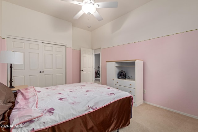 bedroom with light carpet, a closet, and ceiling fan