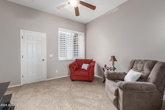 living area with ceiling fan, carpet flooring, and lofted ceiling